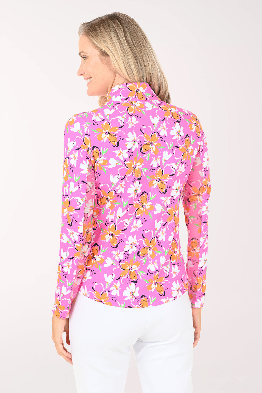 Woman wearing a pink floral long-sleeve shirt on a white background