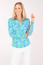 Woman wearing a blue and green patterned long-sleeve shirt on a white background