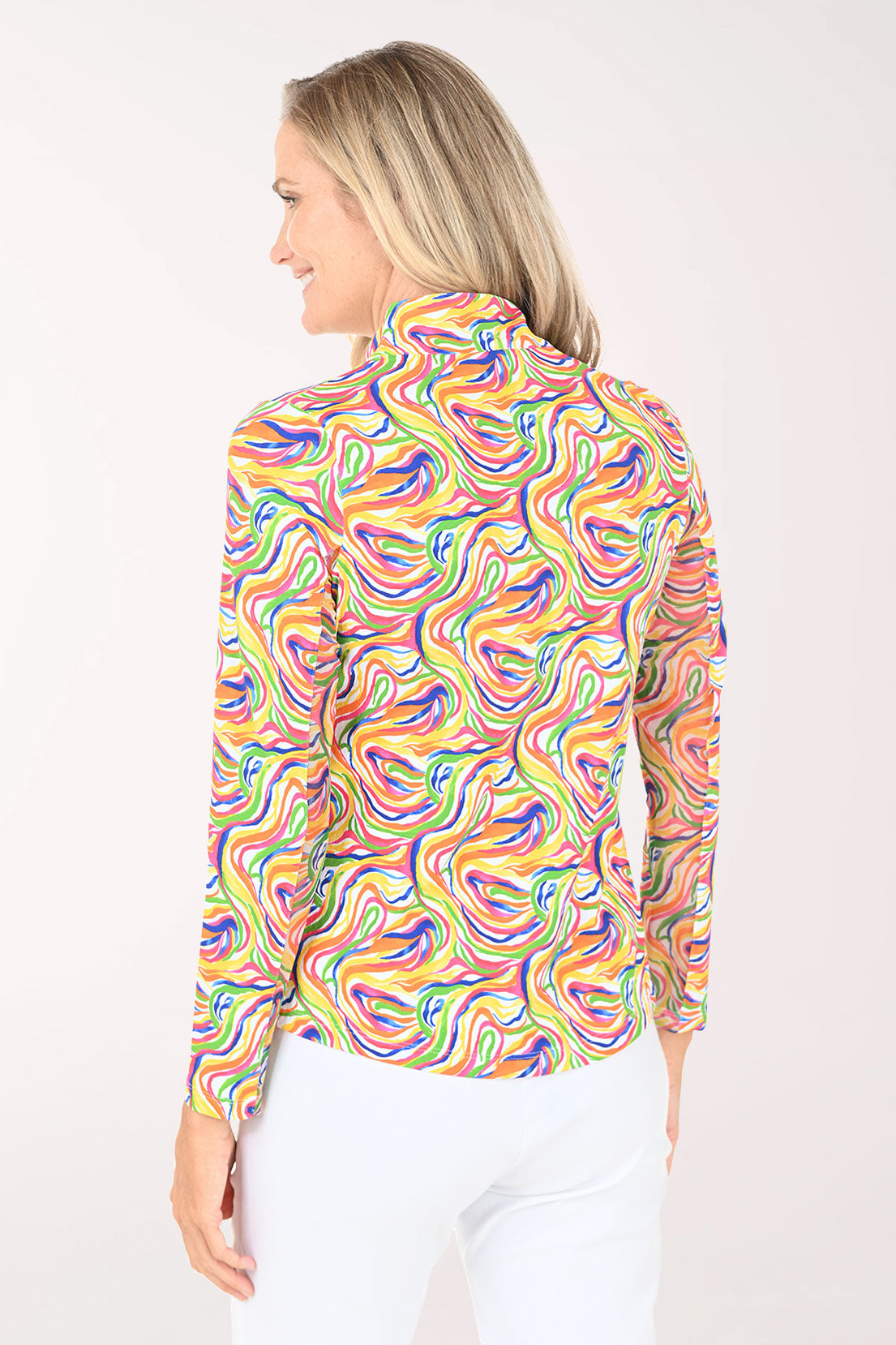 Woman wearing a colorful patterned shirt on a white background