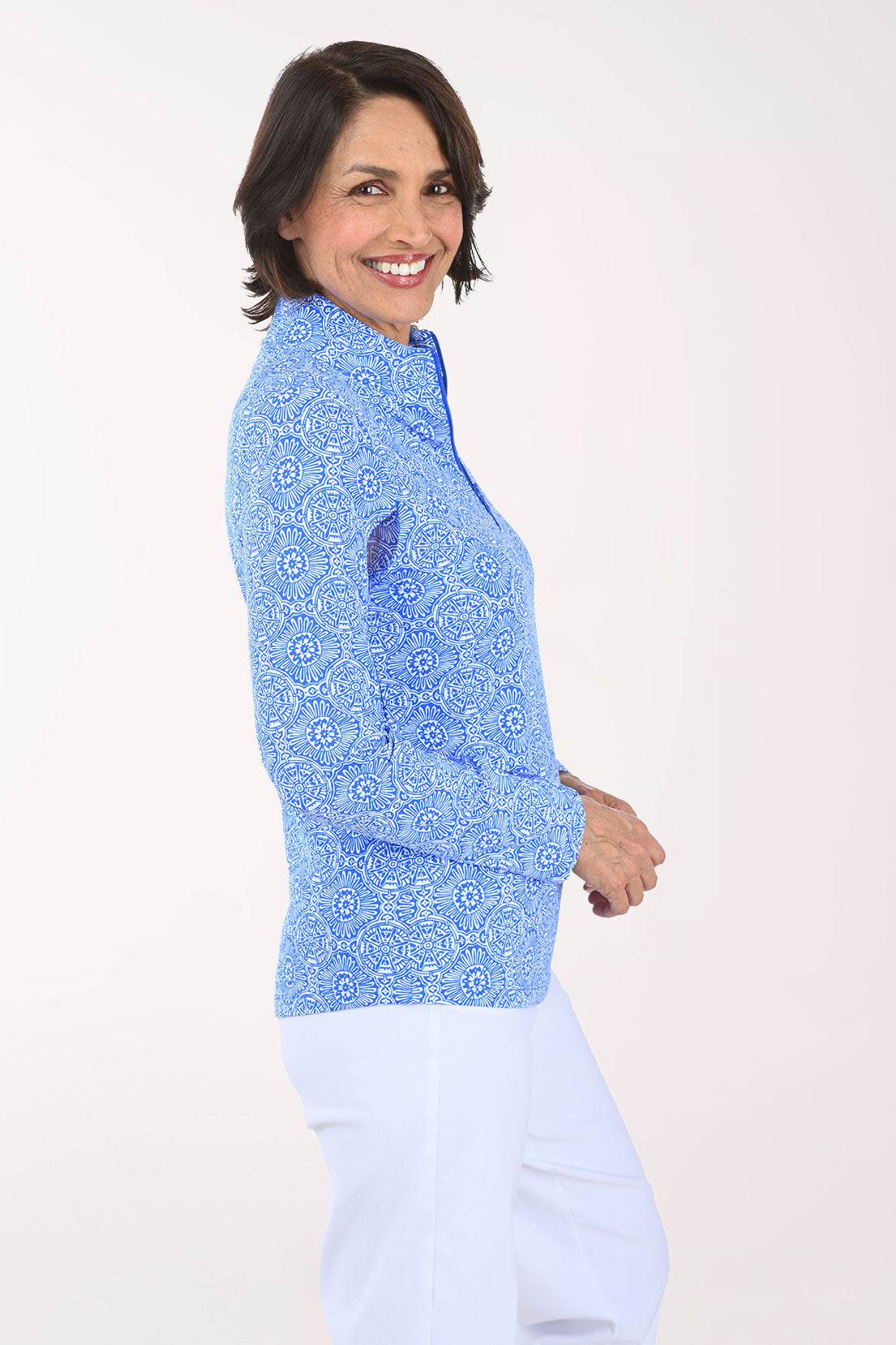 Woman wearing a blue patterned long-sleeve shirt on a white background