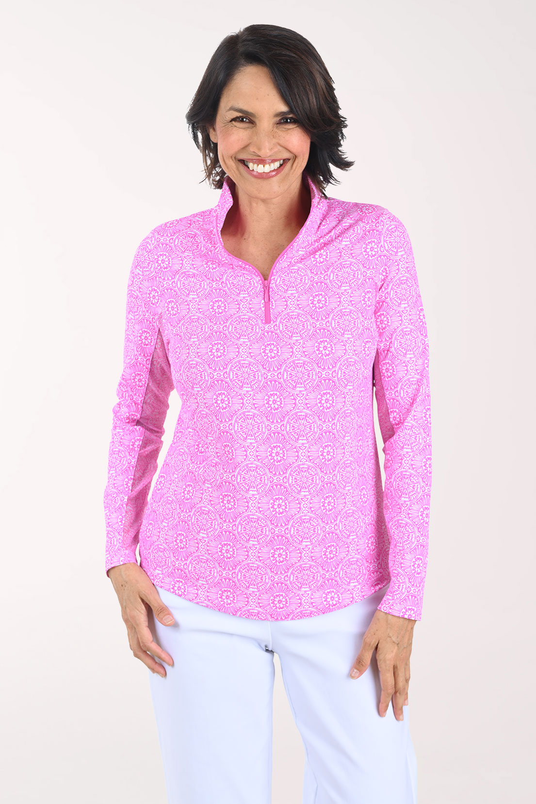 Woman wearing a pink patterned long-sleeve shirt on a white background