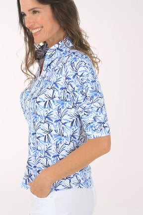 Woman wearing a blue floral patterned shirt on a white background