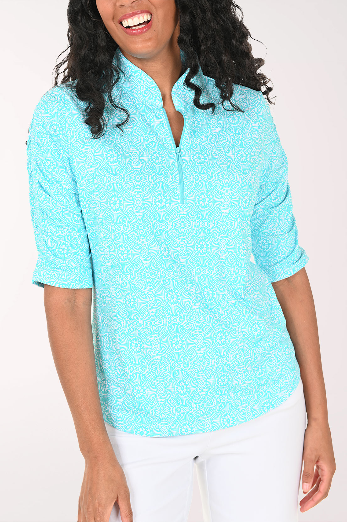 Woman wearing a light blue short-sleeve shirt with a white background