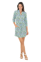 Woman wearing a floral dress on a white background.