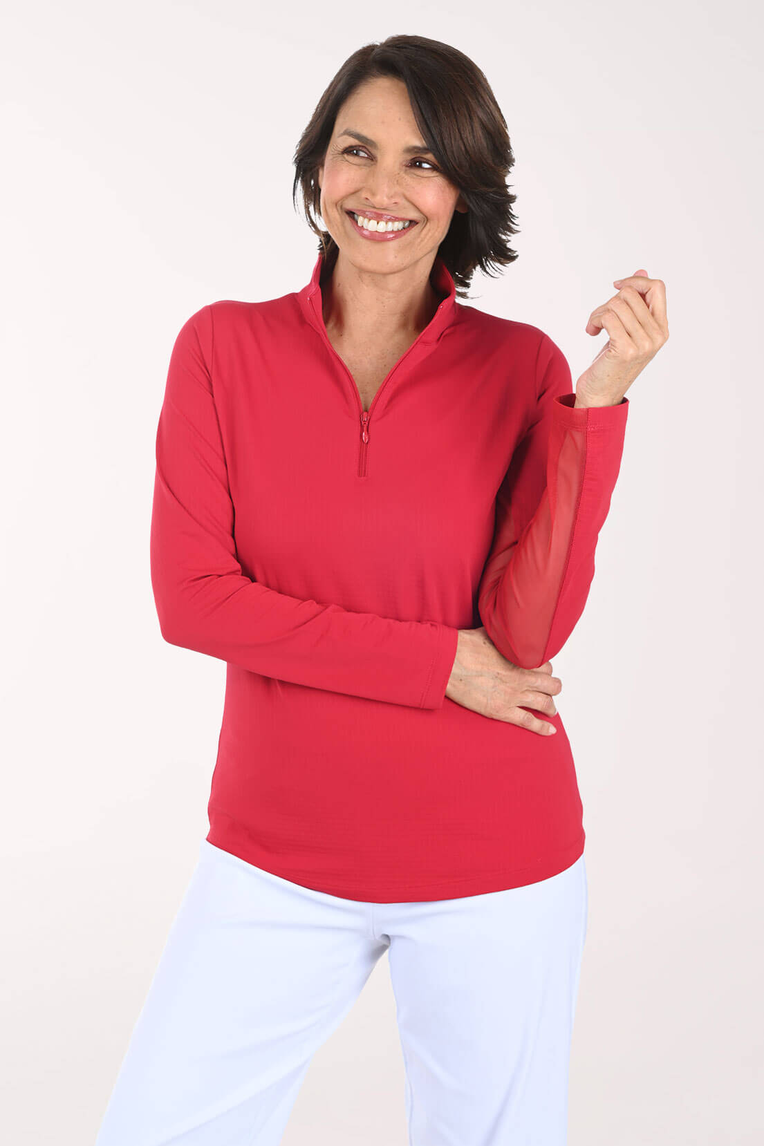 Woman wearing a red long-sleeve top with a quarter zip on a white background