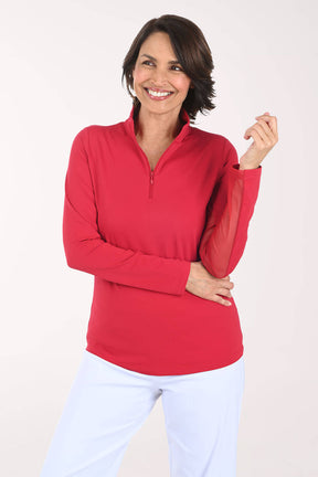 Woman wearing a red long-sleeve top with a quarter zip on a white background
