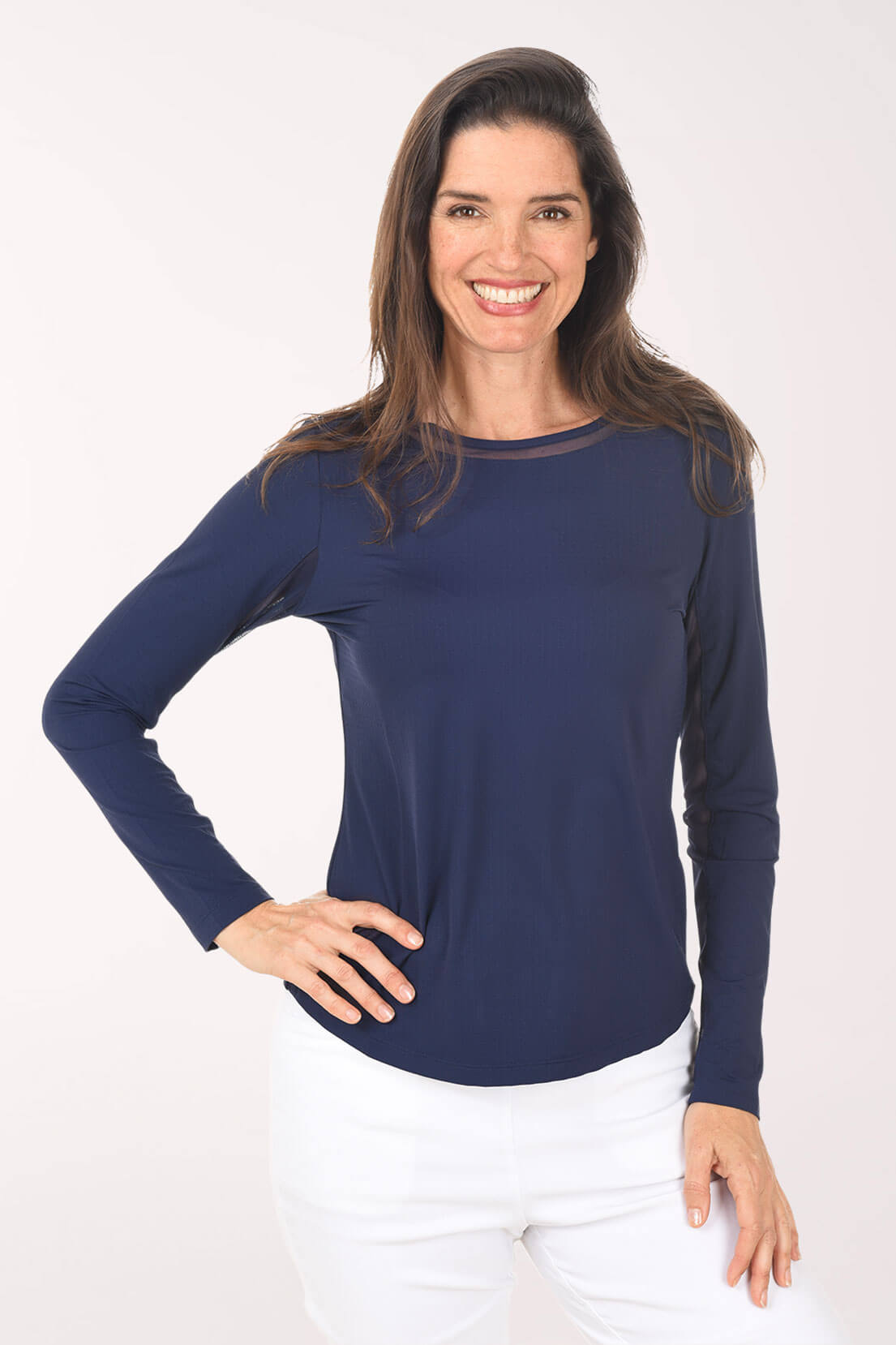 Woman wearing a navy long-sleeve top on a white background