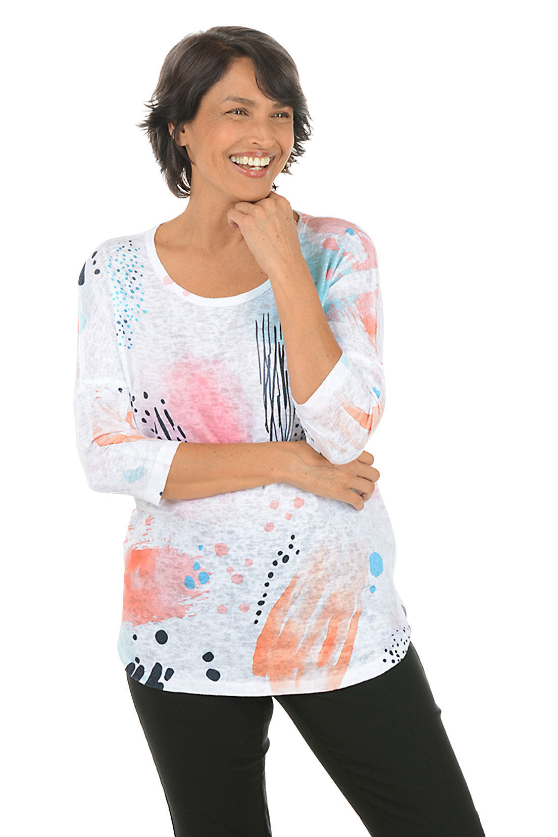 Woman wearing a colorful abstract patterned top on a white background.