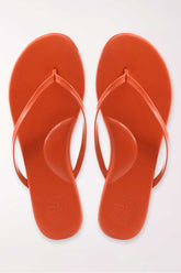 Pair of orange flip-flops on a white background