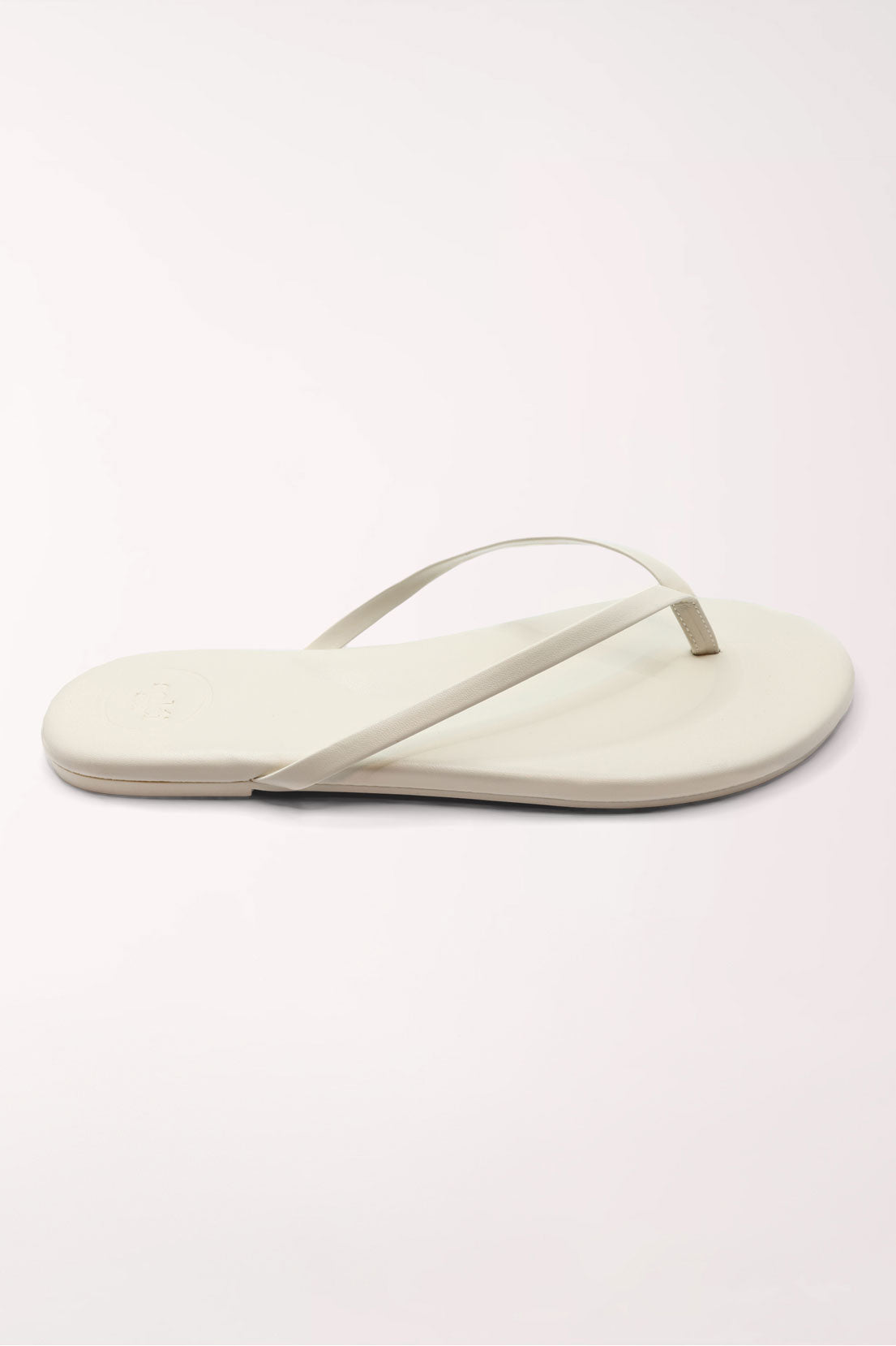 Pair of white flip-flops on a light gray background