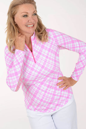 Woman wearing a pink and white checkered long-sleeve shirt on a white background
