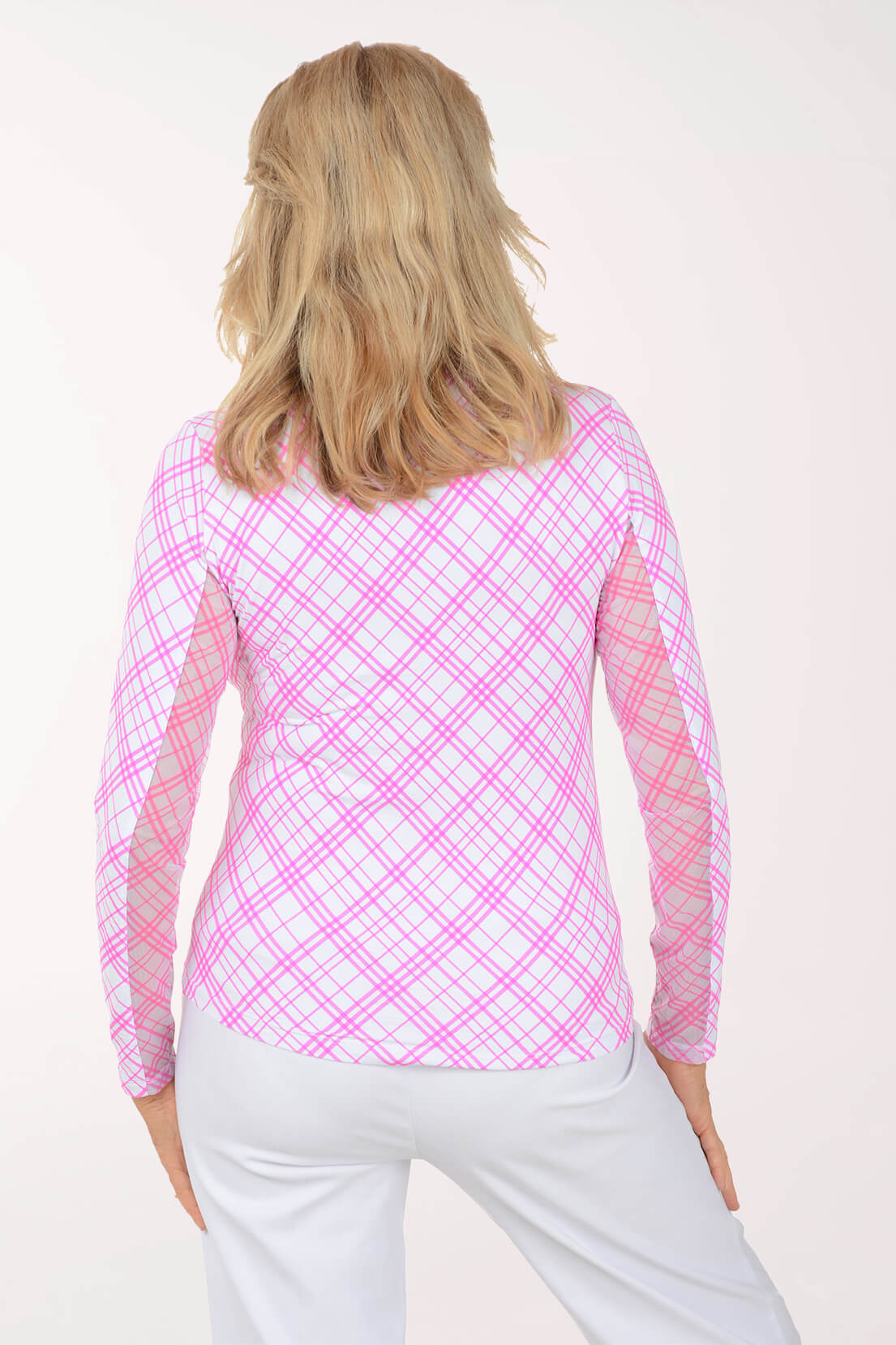 Woman wearing a pink plaid long-sleeve top on a white background