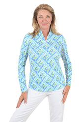 Woman wearing a blue patterned long-sleeve shirt on a white background.