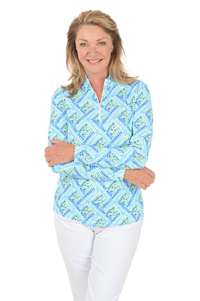 Woman wearing a blue patterned long-sleeve shirt on a white background. Second front shot.