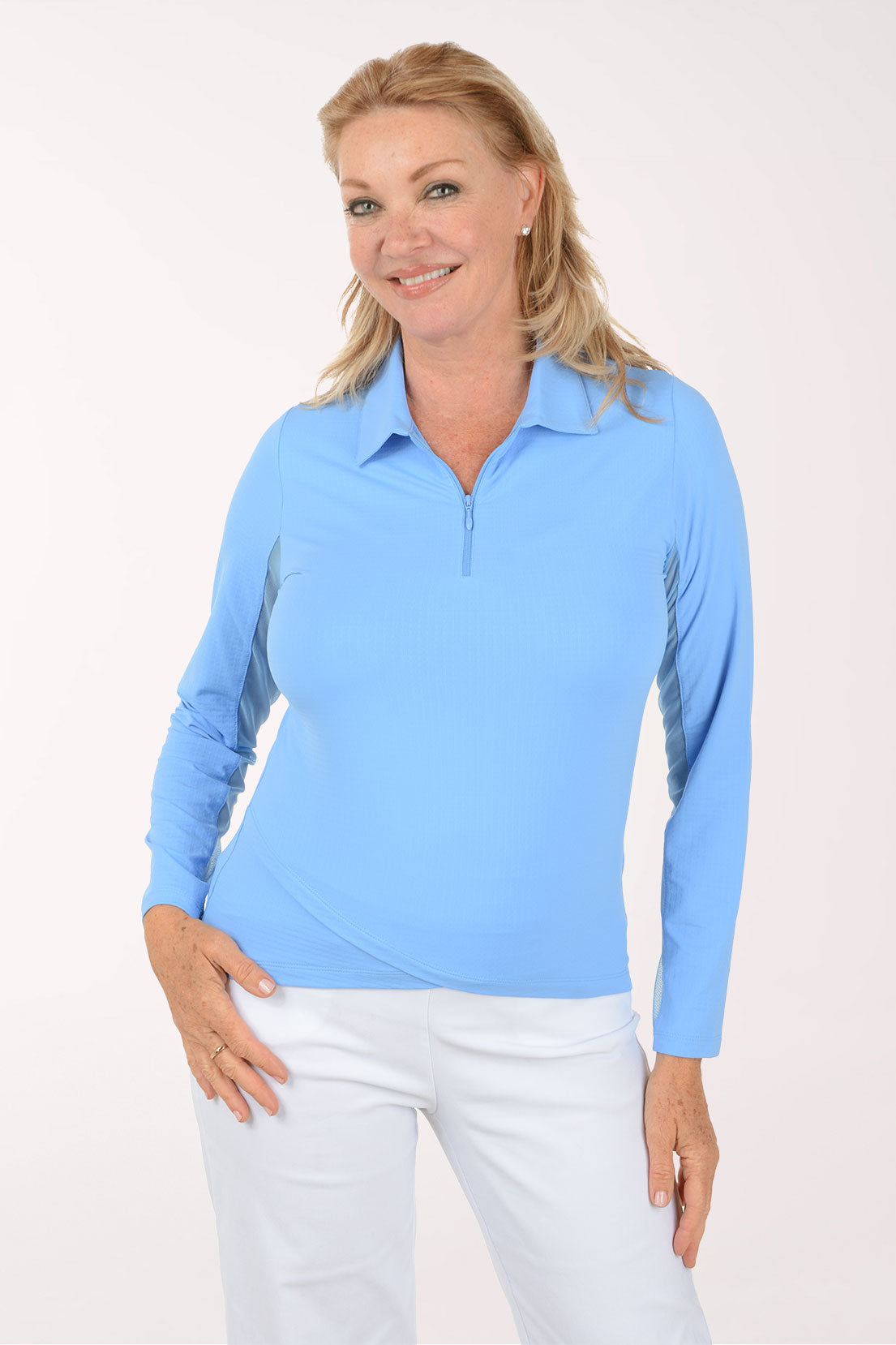 Woman wearing a light blue long-sleeve shirt with a collar on a white background