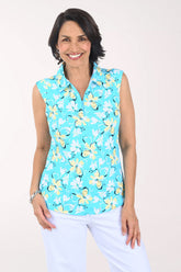 Woman wearing a sleeveless turquoise shirt with yellow floral pattern on a white background