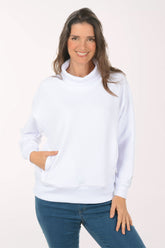 A woman wearing a white funnel neck sweater.