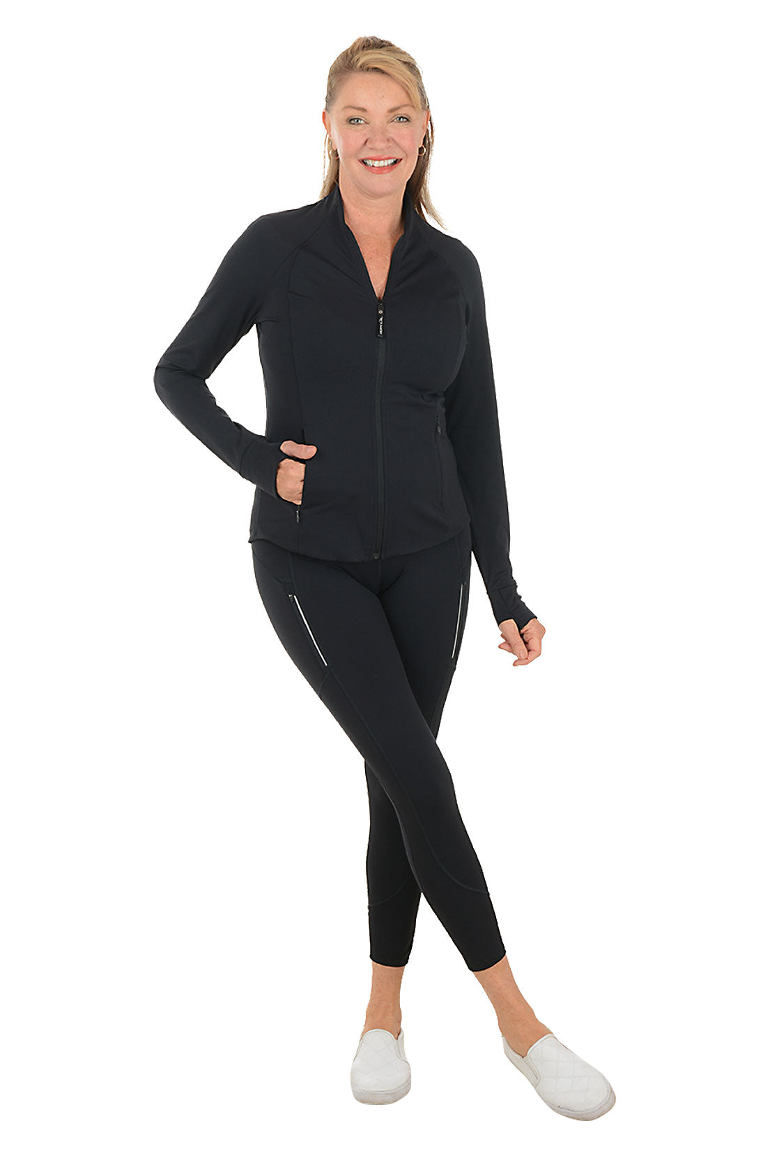 Woman wearing a black athletic outfit on a white background. Second full length shot.