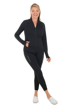 Woman wearing a black athletic outfit on a white background. Second full length shot.