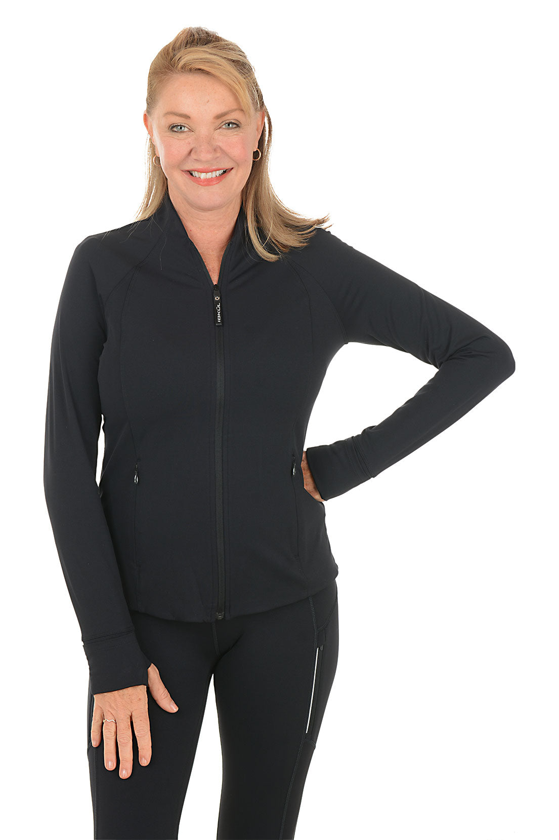 Woman wearing a black zip-up jacket and pants on a white background.