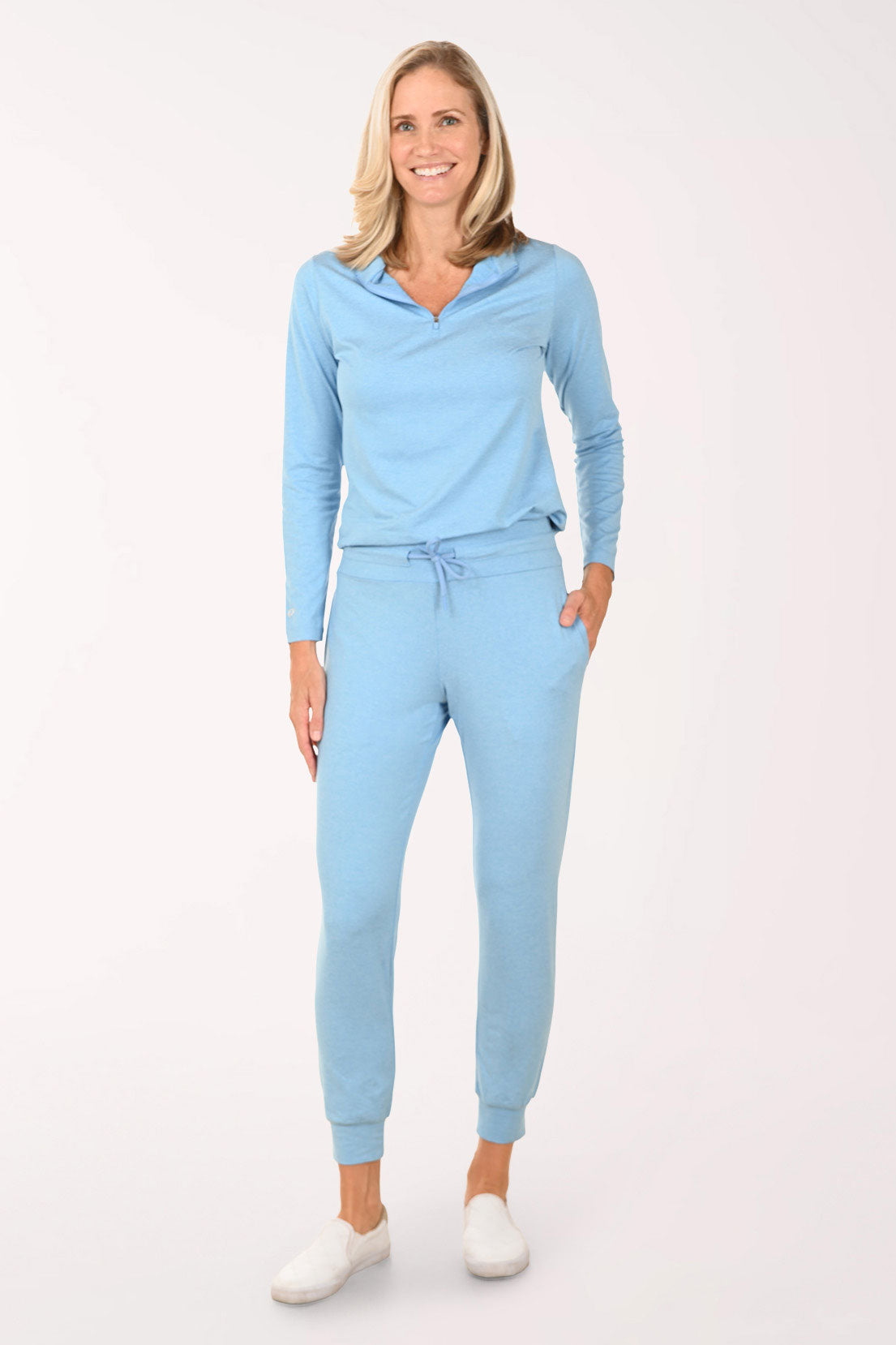 Woman wearing a light blue outfit on a white background