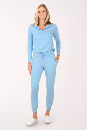 Woman wearing a light blue outfit on a white background