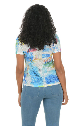 Woman wearing a colorful patterned shirt with a white background. Back shot.