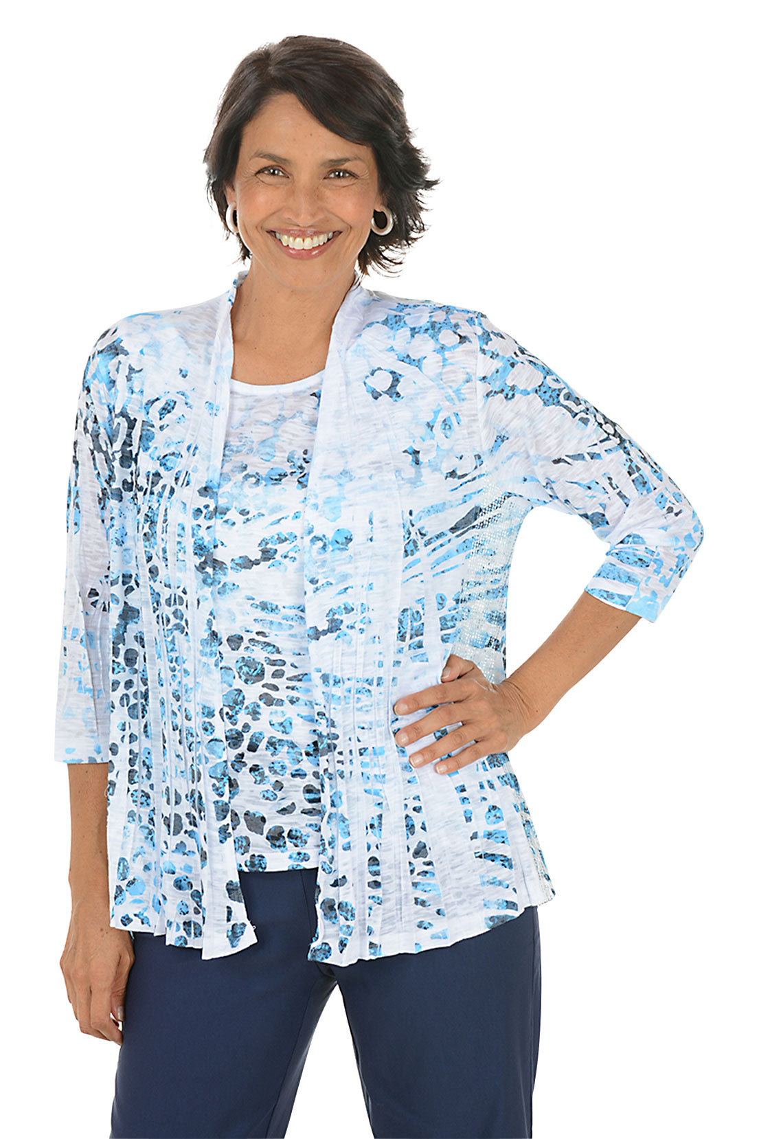 Woman wearing a blue floral cardigan over a white top on a white background. Second front shot.