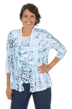 Woman wearing a blue floral cardigan over a white top on a white background. Second front shot.