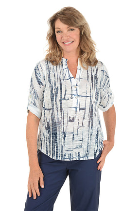A woman wearing a 3/4 roll sleeve navy and white top. Second front shot.