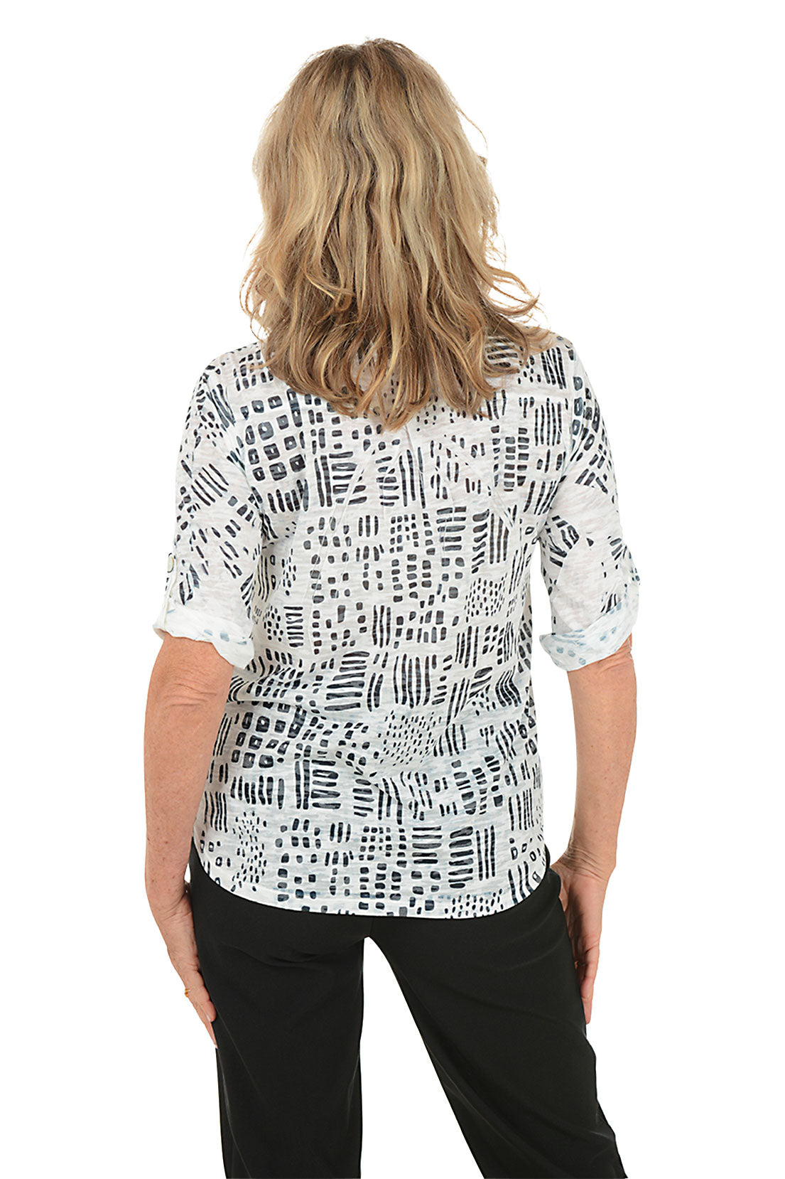 A woman wearing a 3/4 roll sleeve black and white top. Back shot.