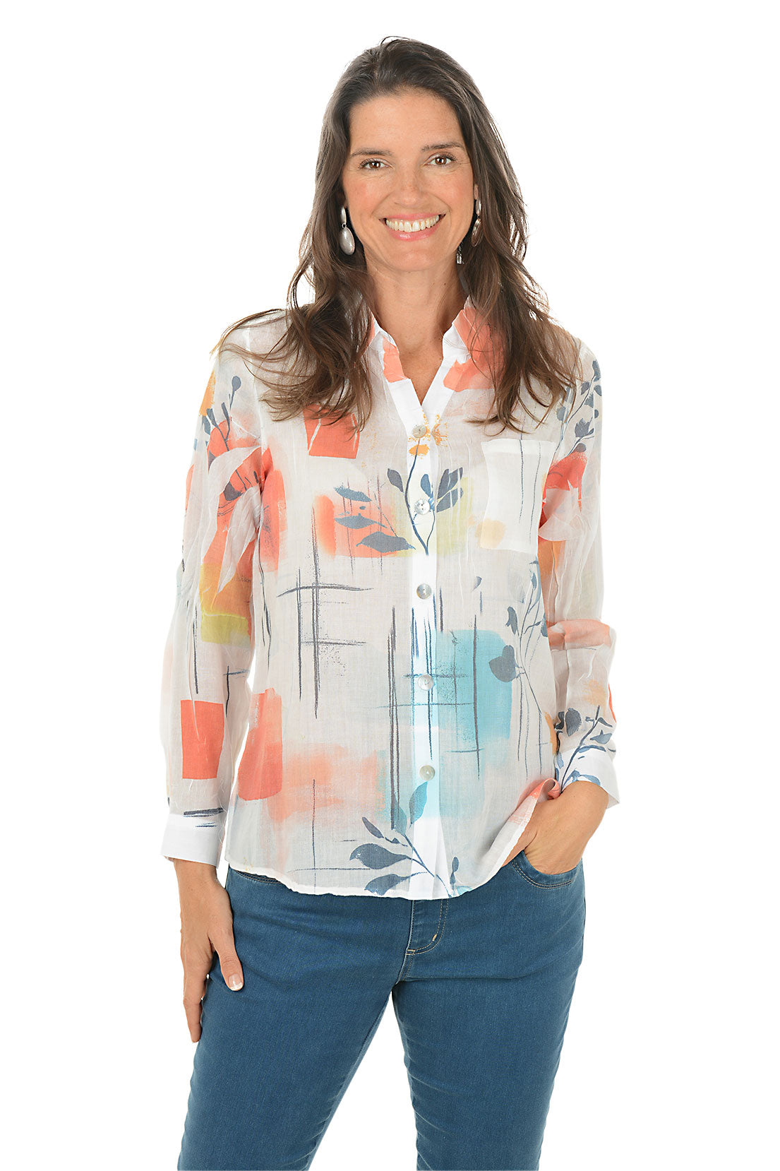 Woman wearing a colorful floral blouse with blue jeans on a white background.