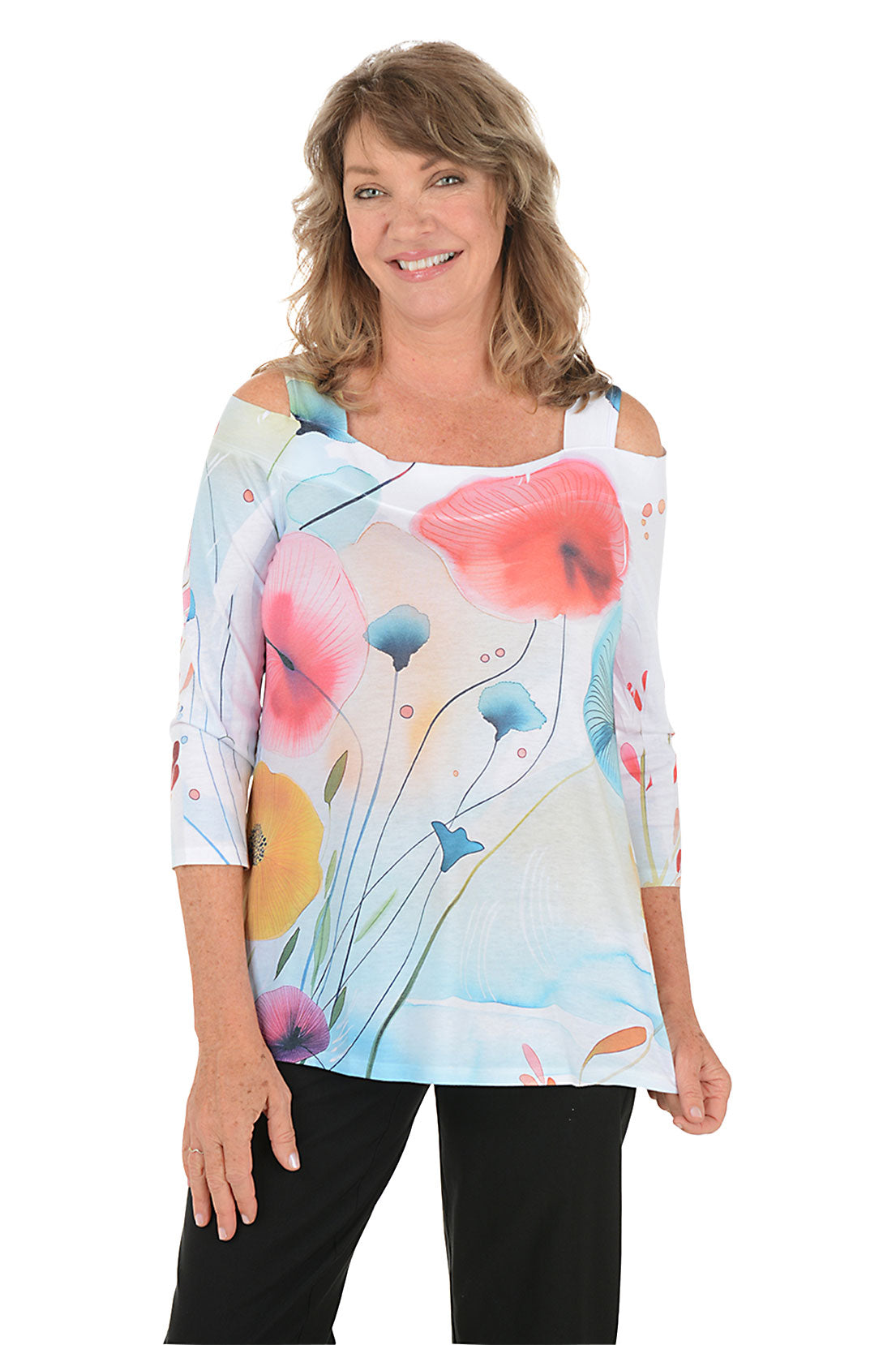 Woman wearing a colorful floral top against a white background.
