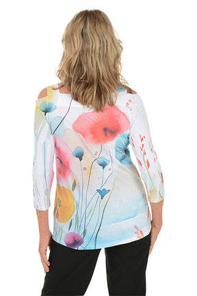 A woman wearing a 3/4 sleeve cold shoulder top in white with a multicolored watercolor floral print. Back shot.
