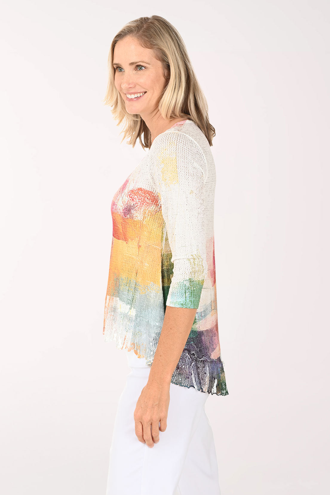 Woman wearing a colorful floral top against a white background