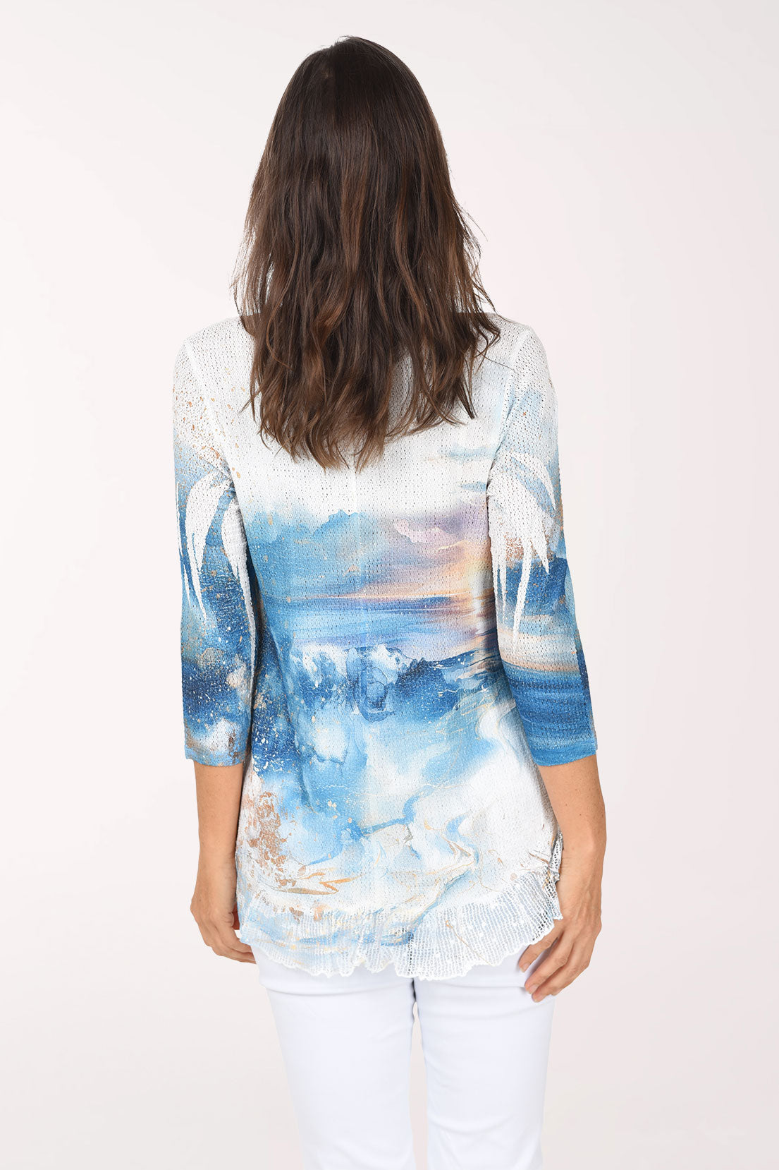 Back view of the top with the ocean sunset scene and palm fronds across the back