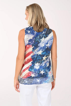 Woman wearing a sleeveless top with a colorful American flag design on a white background