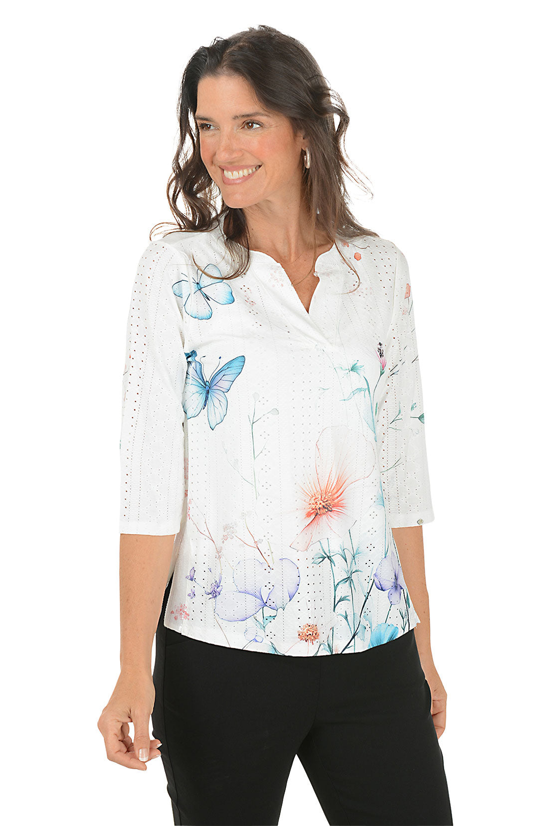 Woman wearing a white blouse with colorful floral pattern on a white background. Second front shot.