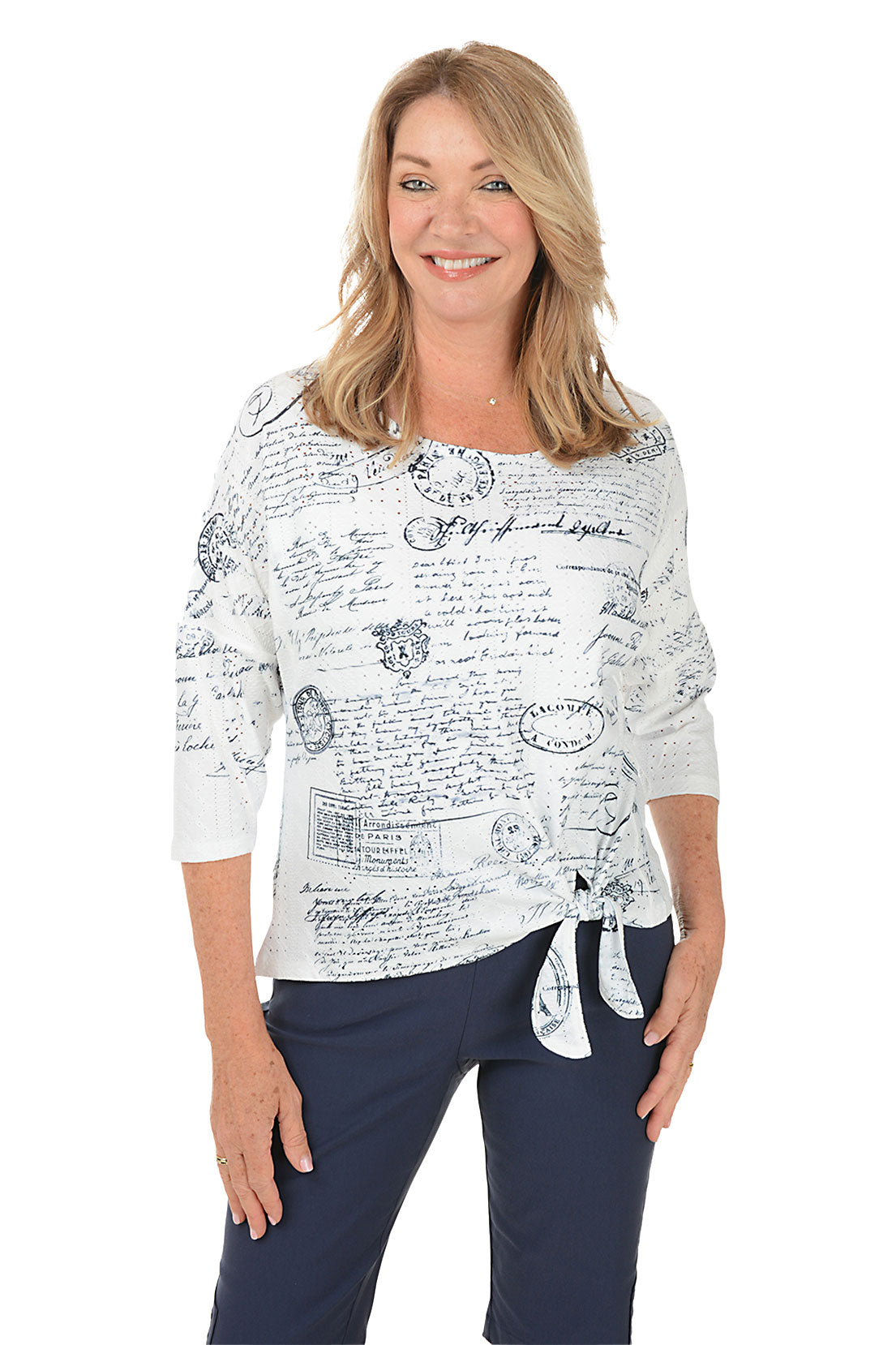 Woman wearing a white blouse with black text and graphics, standing against a white background.