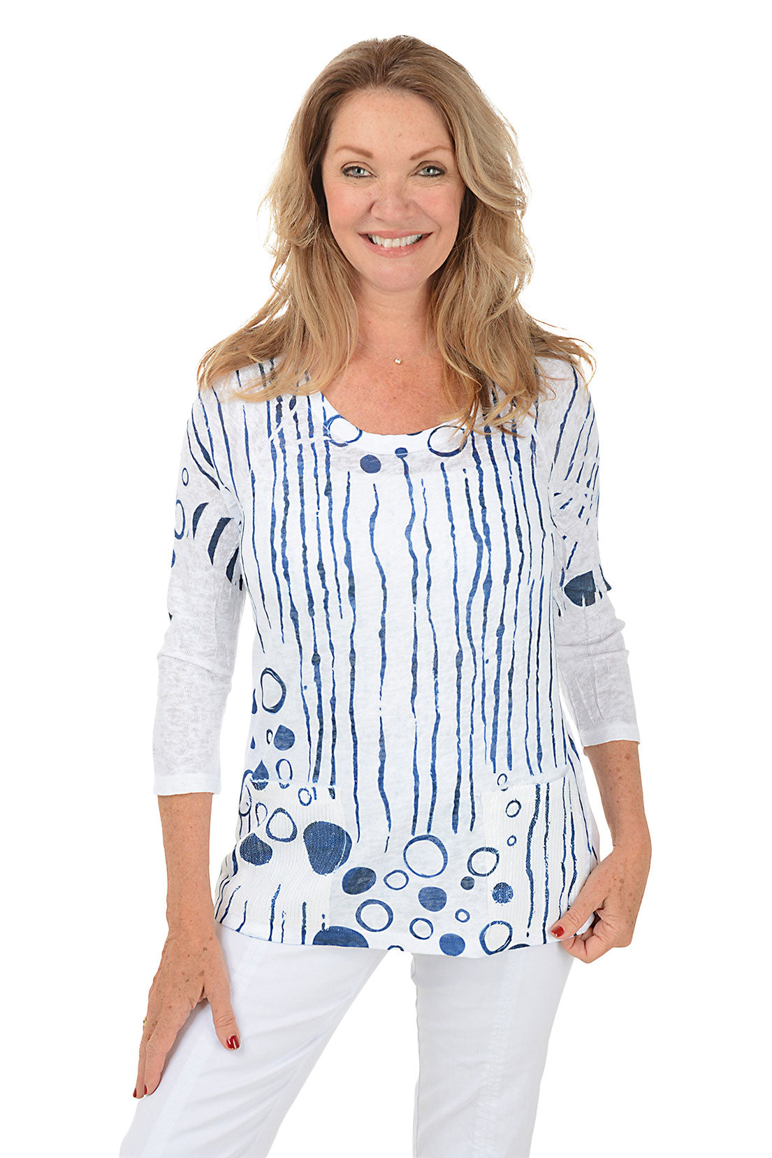 Woman wearing a white top with blue abstract patterns on a white background.