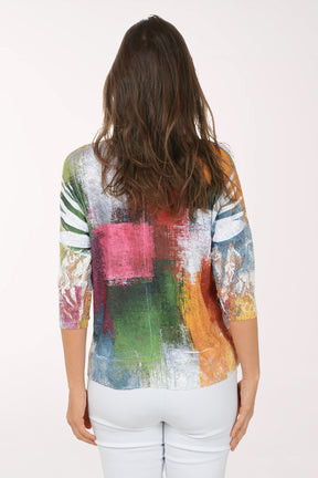 Woman wearing a colorful, patterned top on a white background