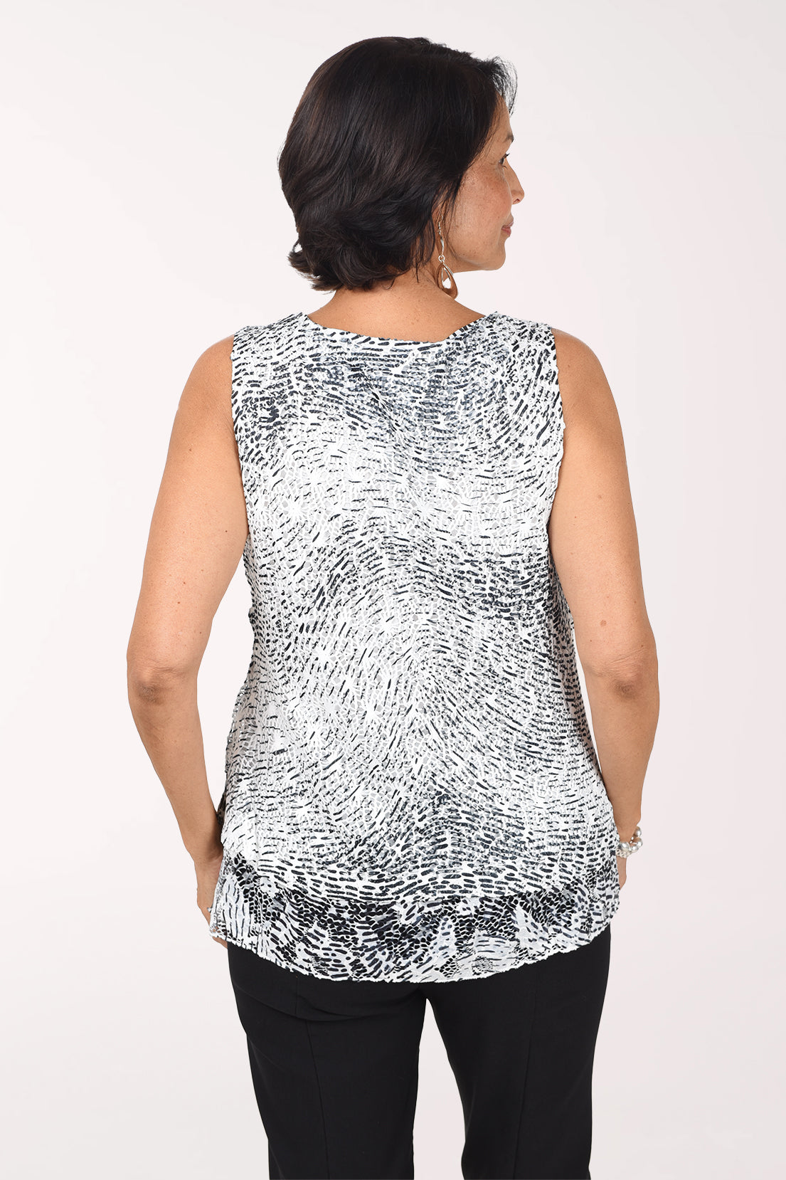 Back view of the Etched Currents sleeveless crochet top showing the etched print continuing across the back to the lace hem.