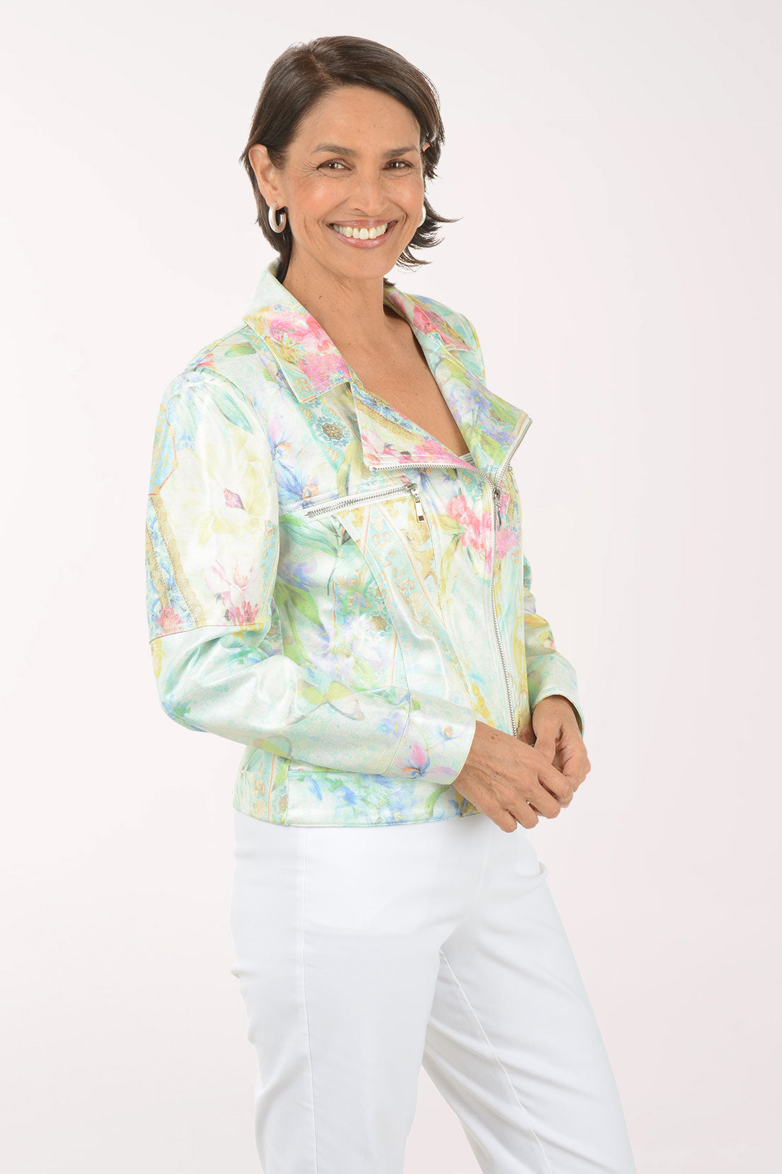Woman wearing a colorful floral jacket on a white background