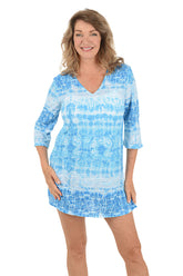 A woman wearing a blue and white 3/4 sleeve cover-up.