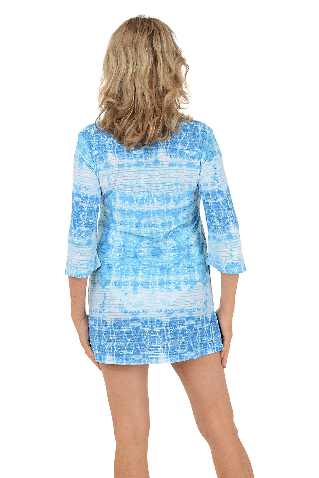 A woman wearing a blue and white 3/4 sleeve cover-up. Back shot.