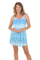 A woman wearing a blue sleeveless dress cover-up and ring detail on the sleeve.