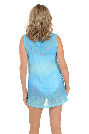 A woman wearing a sleeveless aqua buttoned-up cover-up. Back shot.