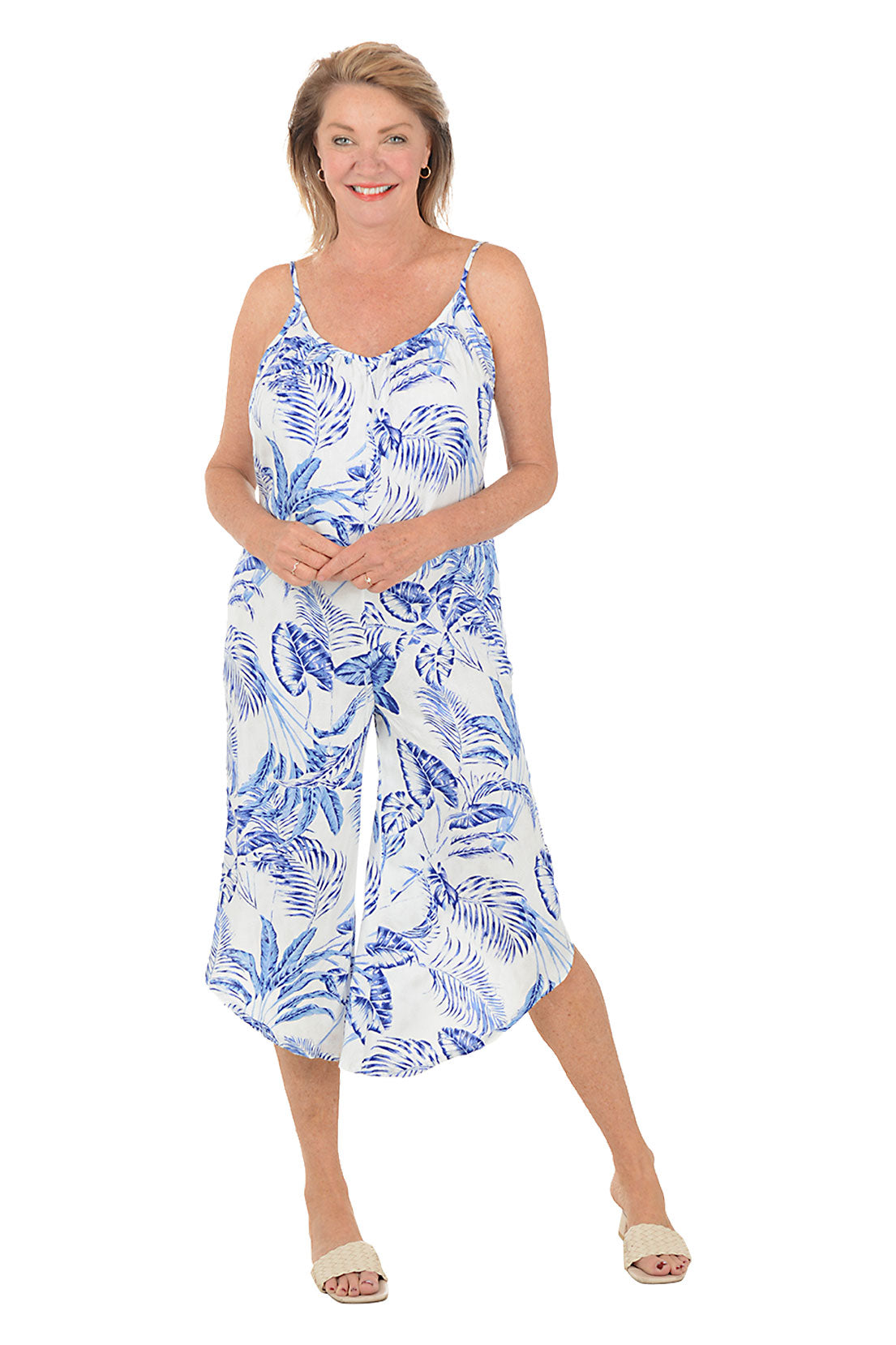 Woman wearing a blue and white floral dress on a white background.