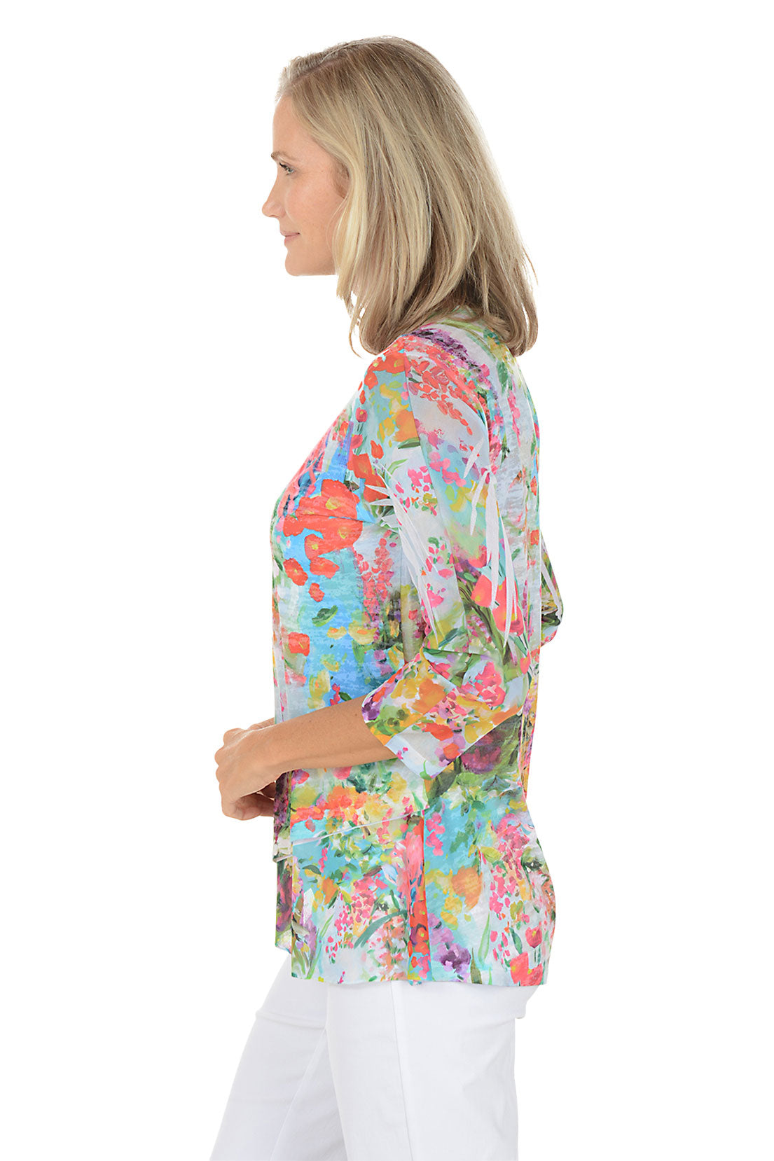 A woman wearing a floral patterned 3/4 sleeve top. Side shot.