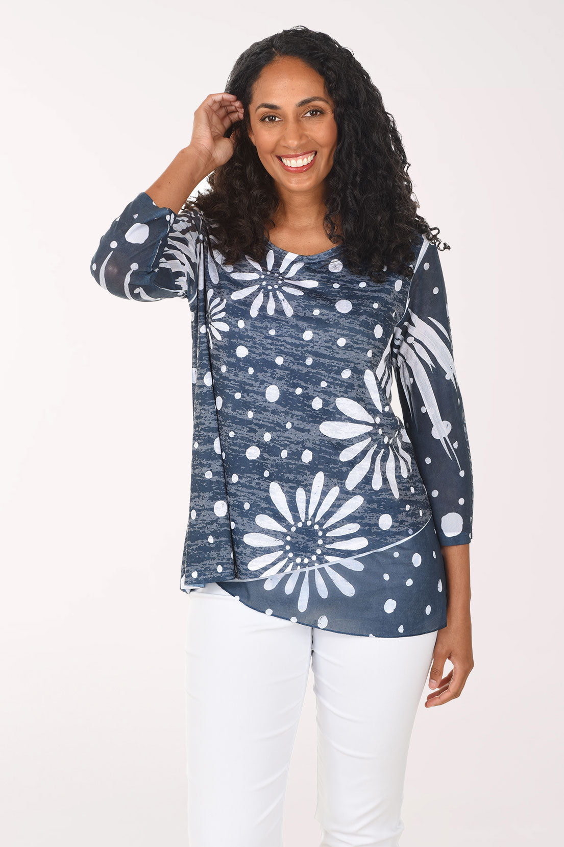 Woman wearing a blue floral patterned top on a white background